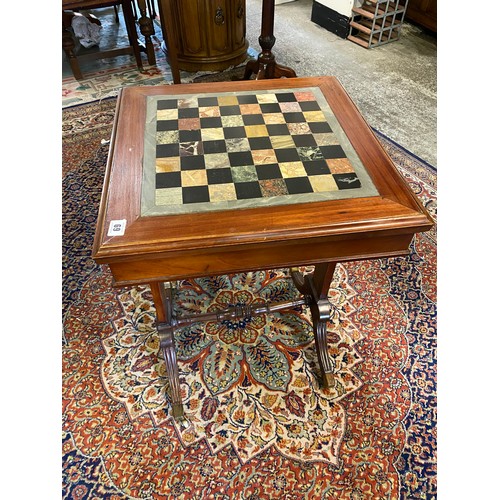 69 - A 19th Century games table with inset specimen hardstone chess board, on panelled ends and reeded do... 