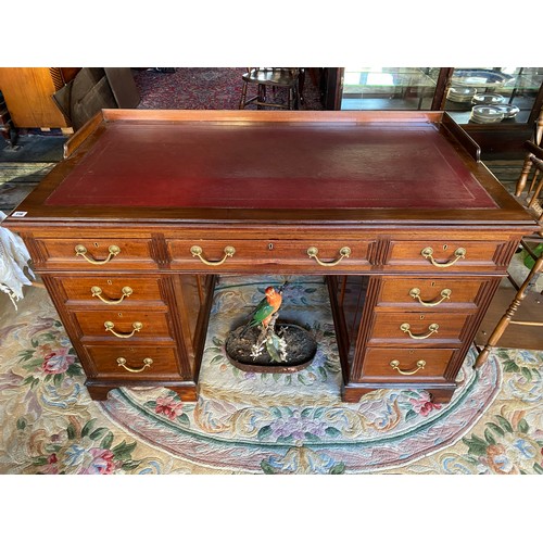 116 - A large Victorian mahogany pedestal desk with three quarter galleried top inset red leather writing ... 