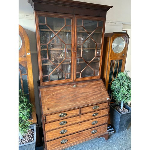 65 - A Georgian mahogany and satinwood inlaid bureau bookcase, the upper part fitted two glass panelled d... 