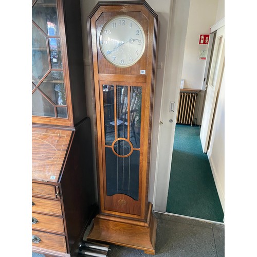 105 - A 1930's longcase clock, circular silvered dial, chiming movement, in a walnut case with glass door