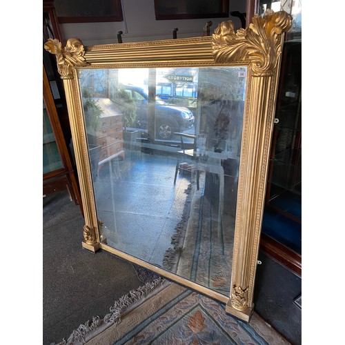 54 - A Victorian overmantel in a gilt frame with leaf form corners - 59in. x 53in.