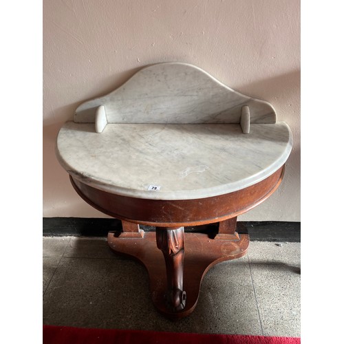 29 - A Victorian mahogany washstand with half round marble top, on three scroll legs -