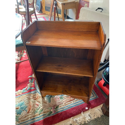 107 - An oak openfront bookcase fitted three shelves, on bracket feet - 24in. wide