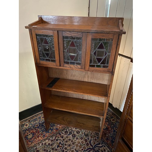 58 - An Edwardian oak bookcase, the upper part fitted three leaded glass doors above three shelves - 28in... 