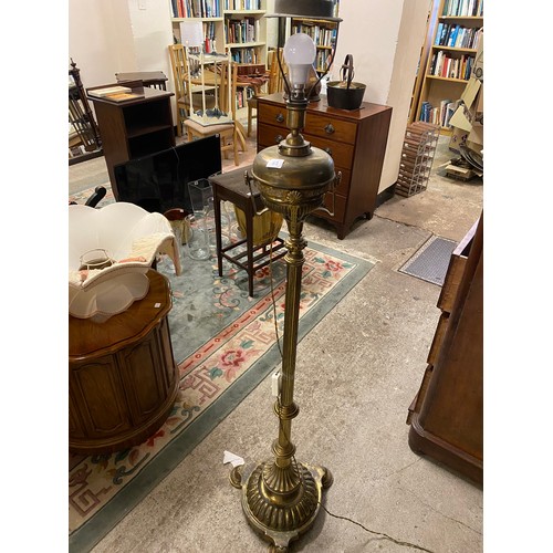 53 - A decorative 19th Century brass and copper fender and a Victorian floor standing brass oil lamp with... 