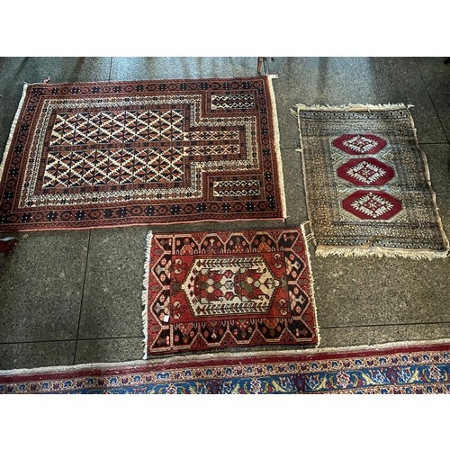 1 - A Bokhara rug, red field with five panels, fringed - 26in. x 35in., an Eastern rug, red field with c... 