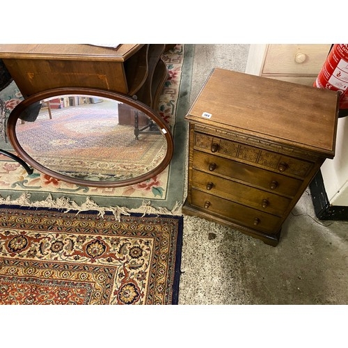 104 - A small oak chest fitted four drawers, acorn knob handles - 19 1/2in. wide and an oval wall mirror i... 