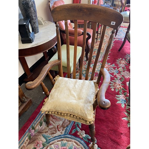 98 - A Windsor armchair with comb shaped back, hard seat, on baluster turned legs