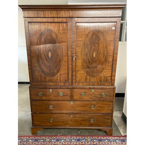 41 - A Georgian mahogany and satinwood inlaid linen press, the upper part fitted two doors with inlaid pa... 