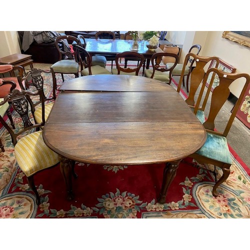 88 - A Victorian mahogany dining table with oval top, extra centre leaf, on moulded legs, a pair of Queen... 