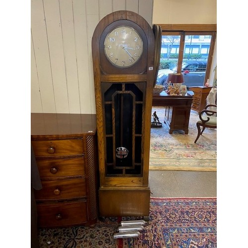 70 - A 1930's longcase clock with circular silvered dial, striking movement, three chrome weights, in an ... 