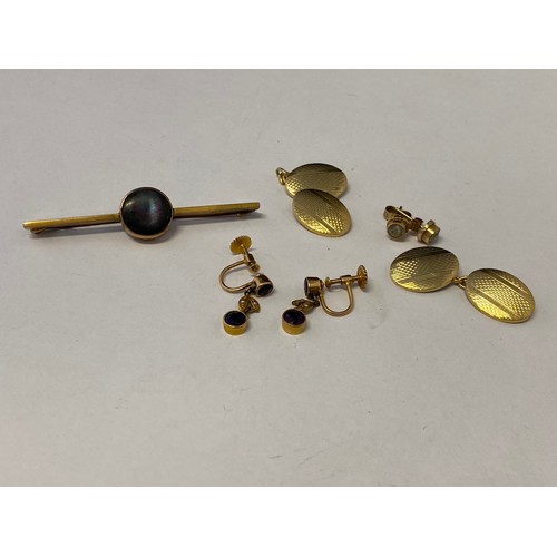 237 - A pair of gold coloured metal cufflinks with engine turned decoration, a 9ct. gold bar brooch set mo... 