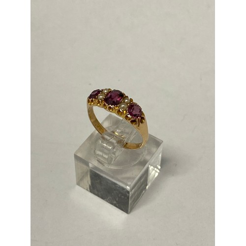 262 - A lady's Victorian ring set three pink stones with seed pearl spacers, on a 15ct. gold shank