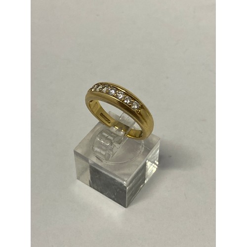 258 - A lady's ring channel set seven diamonds, on an 18ct. gold shank