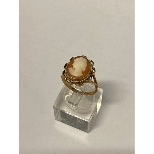 259 - A lady's ring set carved shell cameo, on a 9ct. gold shank with split shoulders