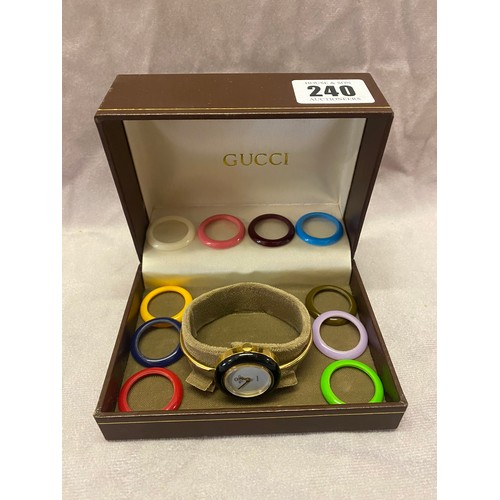 240 - A Gucci gold plated bangle watch with interchangeable coloured bezels, boxed