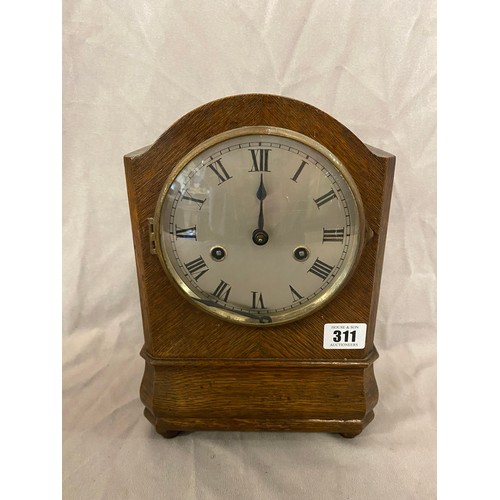 311 - An Edwardian mantel clock, circular silvered dial, in an oak case