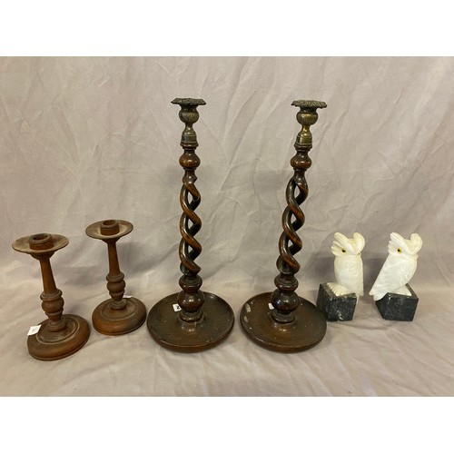 312 - A pair of turned oak candlesticks, a pair of oak candlesticks with barley twist columns and a pair o... 