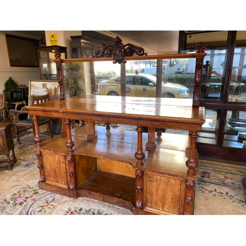 25 - A Victorian mahogany buffet, the raised back with leaf scroll pediment, fitted mirror, four carved f... 