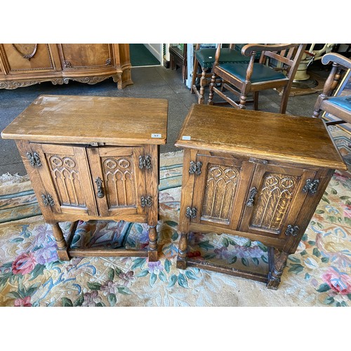 52 - A pair of small oak cabinet fitted two carved panelled doors, on baluster turned legs united by stra... 