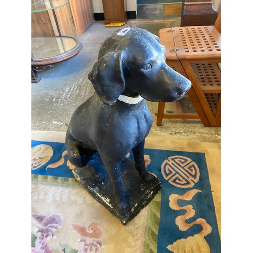 30 - A large black painted plaster model of a seated dog - 30in. high