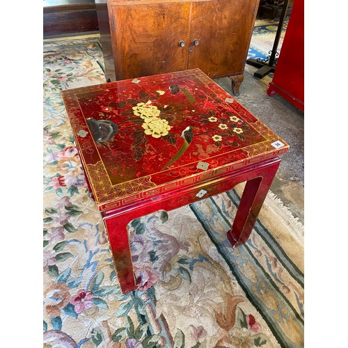 36 - A modern Chinese red lacquered lamp table decorated flowers, on square shaped legs - 20in. wide