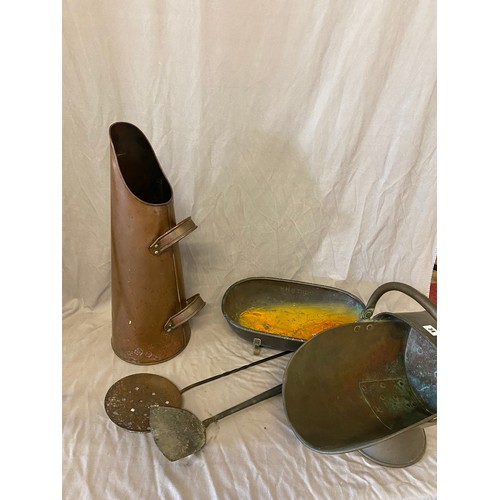 34 - A copper helmet shaped coal bucket, a copper coal scoop, straining spoon and oval dish from HMS Dido