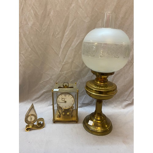 315 - A modern brass oil lamp, a Swiza clock in a lacquered brass case and a Kundo 400 day Anniversary clo... 