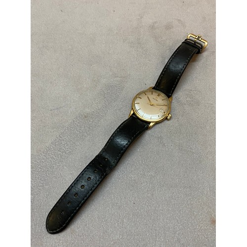 244 - A gentleman's Omega wristwatch in a gold coloured metal case, on black leather strap