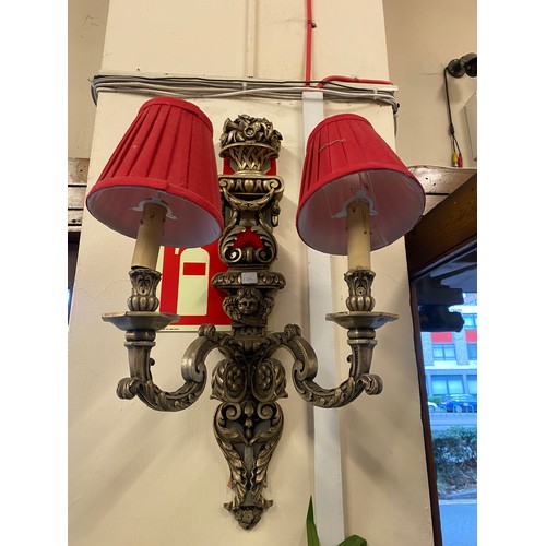 22 - A set of three silver sprayed twin branch wall lights with baskets of flowers to the tops and putti ... 