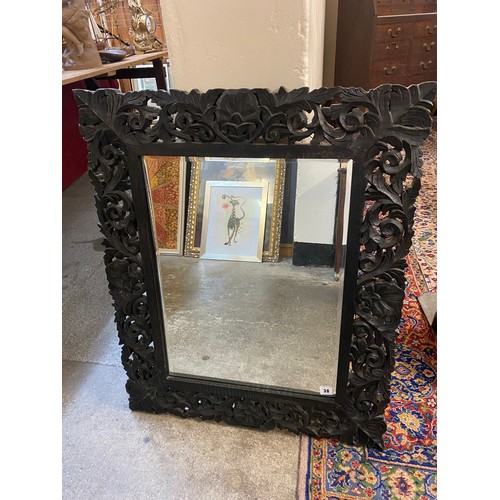 38 - A rectangular bevelled wall mirror in a carved wood frame with leaf scroll and shell decoration - 33... 