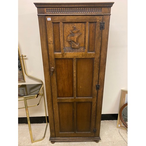 46 - A Fleet Furniture oak hall wardrobe with panelled door depicting a galleon - 29in. wide