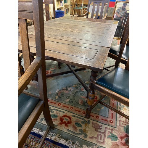 50 - An oak drawleaf dining table, a set of four oak framed dining chairs with vertical splats, a pair of... 