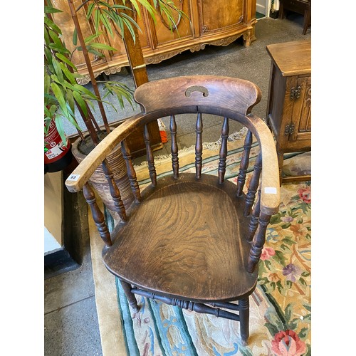 63 - An oak framed elbow chair with turned supports, hard seat, on turned legs