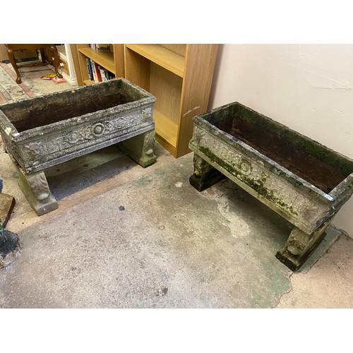 81 - A pair of concrete garden troughs on shaped supports - 37in x 17in.