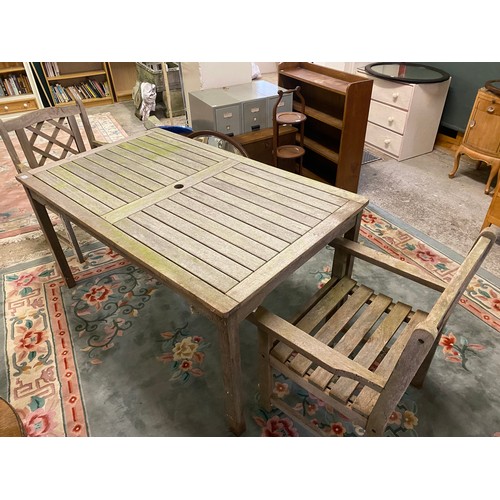 82 - A teak garden table and two chairs