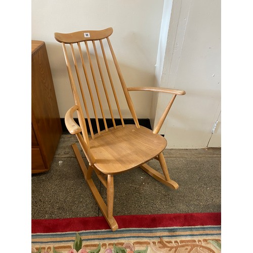 99 - An Ercol light elm rocking chair with stick back and hard seat