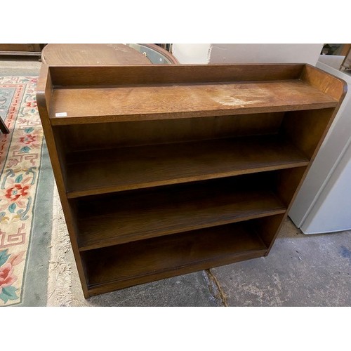 61 - An oak openfront bookcase fitted three shelves - 36in. wide and an oak two tier folding cakestand - ... 