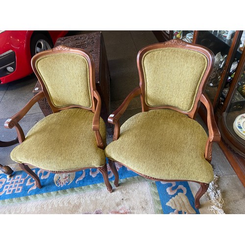 25 - A pair of French style open armchairs upholstered in green chenille style material