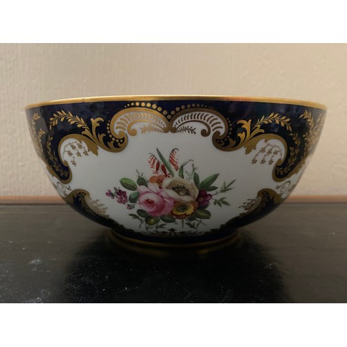 100 - A 19th Century Derby bowl, deep blue ground with gilt leaf scrolls, painted in reserves with flowers... 