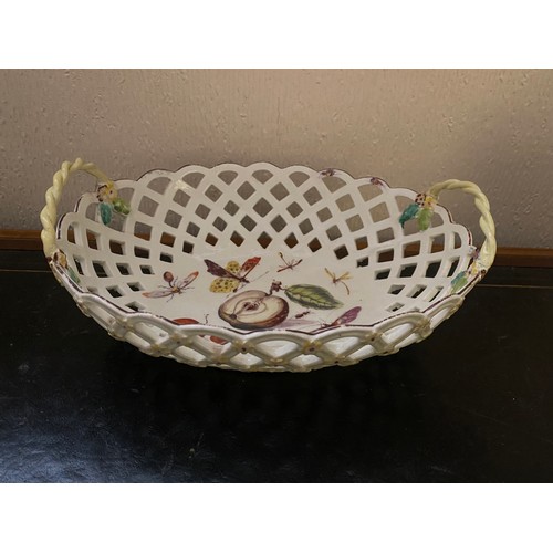 104 - A 19th Century porcelain basket of oval form with yellow vine twist handles with grapes, painted to ... 