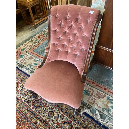 27 - A Victorian nursing chair with scroll back upholstered in buttoned pink material, on short cabriole ... 