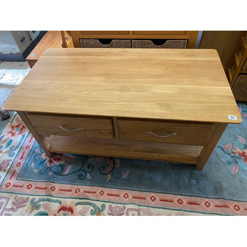 31 - An oak coffee table with rectangular top, fitted two drawers - 43in. wide