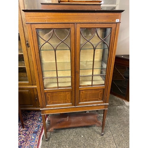 48 - An Edwardian mahogany and satinwood inlaid display cabinet with low raised back, fitted two glass do... 