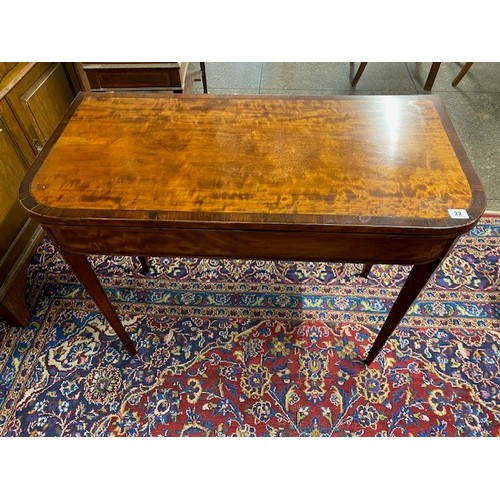 22 - A Georgian satinwood and rosewood crossbanded card table with 'D' shaped folding top, on square tape... 