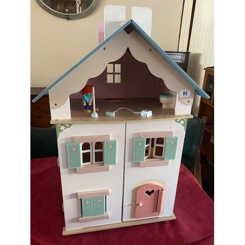 93 - A child's modern wooden painted dolls house complete with a small amount of furniture - 19in. wide a... 