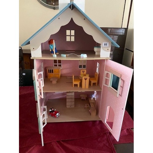 93 - A child's modern wooden painted dolls house complete with a small amount of furniture - 19in. wide a... 