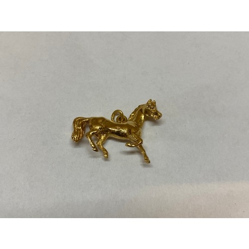 213 - An 18ct. gold charm in the form of a horse