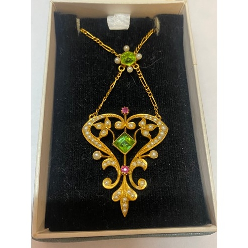 223 - A late Victorian 15ct. gold pendant set peridot and seed pearls, on a fine 15ct. gold chain