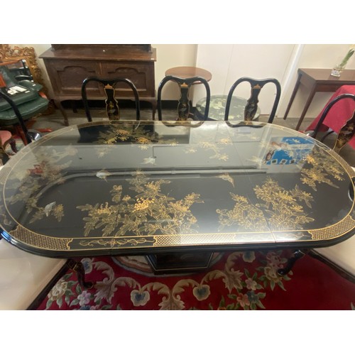 20 - A reproduction black Chinoiserie decorated dining table with extra centre leaf, the top decorated wi... 